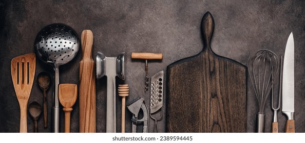 Various kitchen utensils and tools on a brown rustic background, banner. Top view, flat lay. Collection kitchenware.