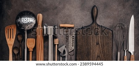 Various kitchen utensils and tools on a brown rustic background, banner. Top view, flat lay. Collection kitchenware.
