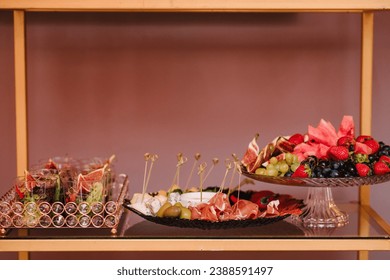 Various light snacks, dishes for holiday. Catering plate on buffet table for party. Beautifully decorated catering banquet table with different food snacks and appetizers. Decoration for a banquet.