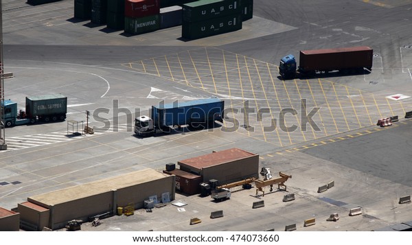 Various loaded container trucks in a port\
sorting yard, Barcelona, Spain, July\
2016