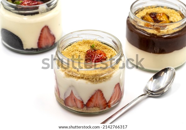 Various magnolia sweets isolated on white\
background. World cuisine delicacies. Magnolia dessert with banana,\
strawberry and biscuit. close\
up