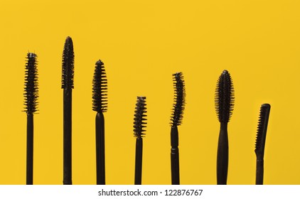 Various Mascara Wands, Isolated On Yellow Background