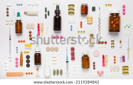 Various medical equipment, thermometer, ampoules, pipette, drugs, tablets, capsules, spray, patch, syringe, vials on a white background. Medicine, pharmacy, hospital, treatment, pharmacy concept.