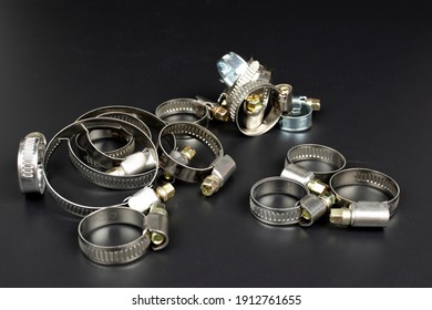 Various metal clamps for hose connection isolated on black background