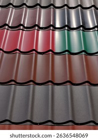 various metal roofing sheets in multiple colors are arranged in construction yard. sheets showcase different finishes and textures, designed for roofing applications. close up.
