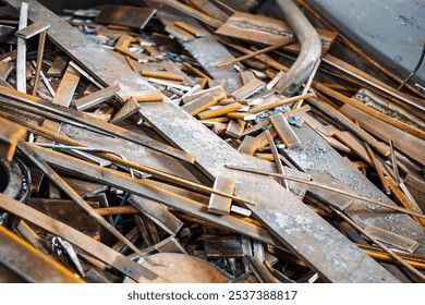 Various metal scraps lie scattered, ready for recycling at an industrial yard under natural light. - Powered by Shutterstock