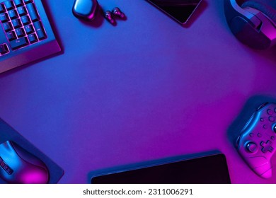 Various modern wireless gadgets on illuminated desk
