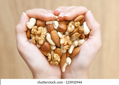 Various nuts in woman hands  forming heart shape - Powered by Shutterstock