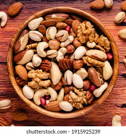 Various Nuts In Wooden Bowl, Top View.