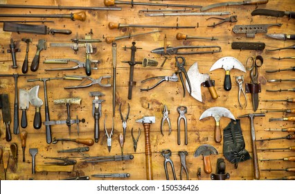 Various old tools on the wall in leather craft workshop - Powered by Shutterstock