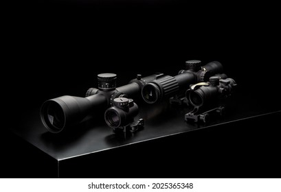Various optical and collimator sights on a dark background. Sniper optical devices for long-medium range shooting.