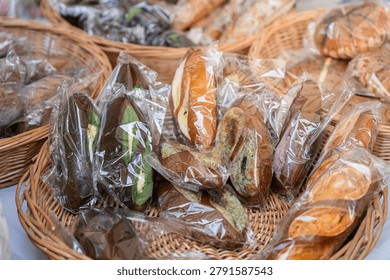 various packaged handmade breads arranged in wicker basket