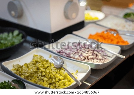 Various pickles on different plates in a buffet