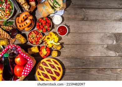 Various Picnic Barbeque Food And Drink Flatlay. Summer Bbq Picnic Food, Assorted Grilled Meats, Kebabs, Vegetable, Fruit Salad, Traditional Picnic Summer Pie Cake, Sandwiches, Top View Copy Space