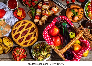 Various Picnic Barbeque Food And Drink Flatlay. Summer Bbq Picnic Food, Assorted Grilled Meats, Kebabs, Vegetable, Fruit Salad, Traditional Picnic Summer Pie Cake, Sandwiches, Top View Copy Space