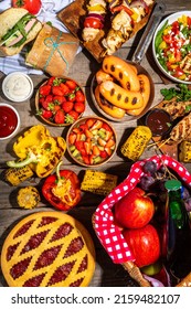 Various Picnic Barbeque Food And Drink Flatlay. Summer Bbq Picnic Food, Assorted Grilled Meats, Kebabs, Vegetable, Fruit Salad, Traditional Picnic Summer Pie Cake, Sandwiches, Top View Copy Space