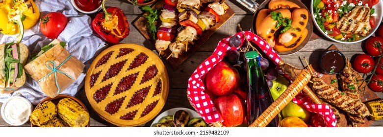 Various Picnic Barbeque Food And Drink Flatlay. Summer Bbq Picnic Food, Assorted Grilled Meats, Kebabs, Vegetable, Fruit Salad, Traditional Picnic Summer Pie Cake, Sandwiches, Top View Copy Space