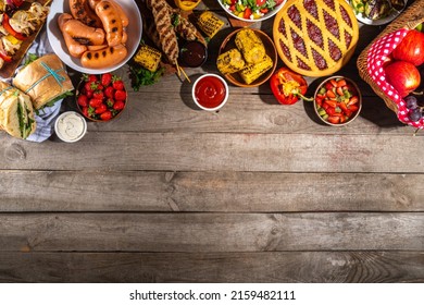 Various Picnic Barbeque Food And Drink Flatlay. Summer Bbq Picnic Food, Assorted Grilled Meats, Kebabs, Vegetable, Fruit Salad, Traditional Picnic Summer Pie Cake, Sandwiches, Top View Copy Space