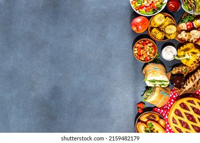 Various Picnic Barbeque Food And Drink Flatlay. Summer Bbq Picnic Food, Assorted Grilled Meats, Kebabs, Vegetable, Fruit Salad, Traditional Picnic Summer Pie Cake, Sandwiches, Top View Copy Space