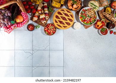 Various Picnic Barbeque Food And Drink Flatlay. Summer Bbq Picnic Food, Assorted Grilled Meats, Kebabs, Vegetable, Fruit Salad, Traditional Picnic Summer Pie Cake, Sandwiches, Top View Copy Space