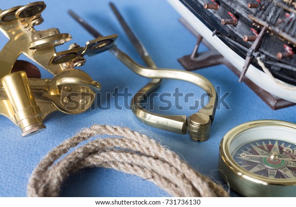 Various\
pieces of nautical equipment on blue\
background
