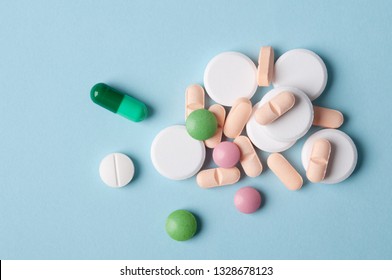 Various Pills And Capsules Of Medicine, Top View On Blue Background; Safe Drugs Use And Medical Treatment Concept