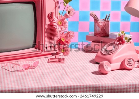 Various pink items placed on pink plaid table against colorful background, decorated by flor gerbera daisy. Photo for advertise product which has organic ingredient, empty space for displaying