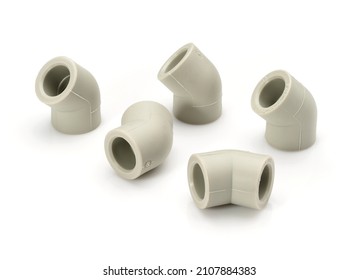 Various plastic fittings for polypropylene pipes on a white background