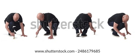 various poses of same man crouching painting on the floor with a brush on white background