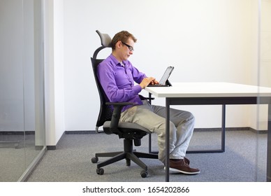 Various Positions Sitting Position At The Office Desk . Man On Chair Working With Tablet