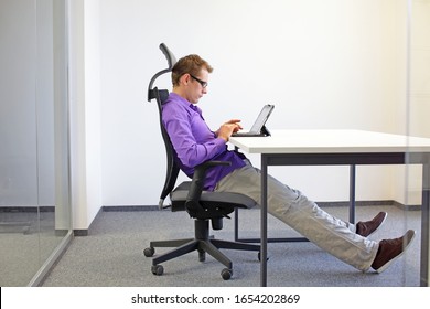 Various Positions Sitting Position At The Office Desk . Man On Chair Working With Tablet