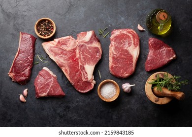 Various raw beef steaks with herbs and spices. Top view flat lay - Powered by Shutterstock