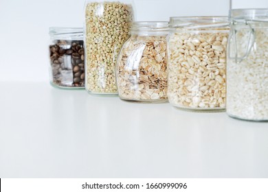 Various raw cereals, grains in glass jars. The concept of zero waste, food storage in the kitchen, healthy nutrition. Copy space for text.