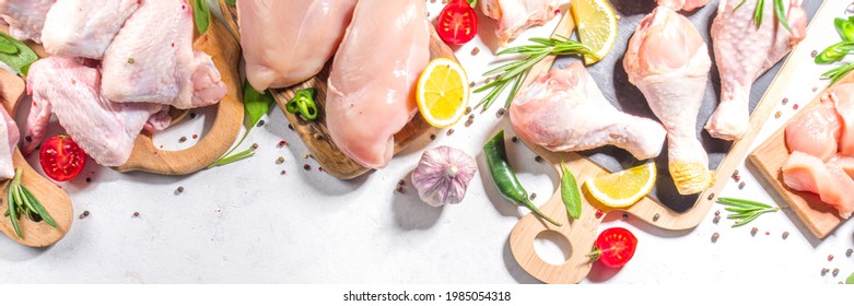 Various Raw Chicken Meat Portions. Set Of Uncooked Chicken Fillet, Thigh, Wings, Strips And Legs On White Cooking Table Background With Spices 