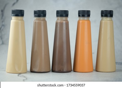 Various Refreshing Coffee And Milk Tea Drinks In Plastic Bottle. Close Up