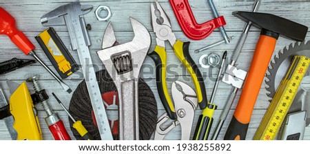 various renovation instruments and tools on grey background. screwdrivers, clamps, wrenches, keys top view