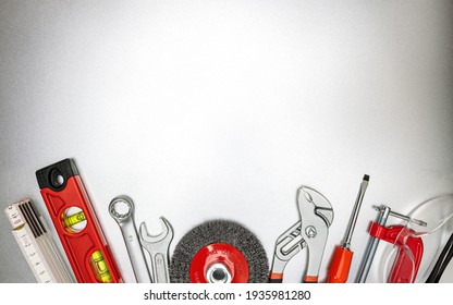 various renovation instruments and work tools on grey metallic desk. top view