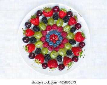 Various ripe berries on the round plate - Shutterstock ID 465886373