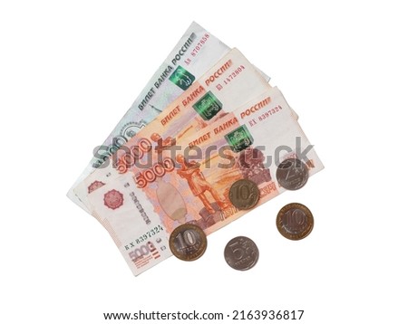 Various Russian money coins and banknotes isolated on white background consisting of one and five thousand Russian rubles banknotes, two, five and ten Russian rubles coins.