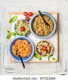 Various Salads Dish On Light Rustic Background. Home Salad Bar. Healthy Food And Vegetarian Eating Concept