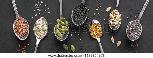 Various Seeds
Assortment on black background. Set of  sesame seeds, flax seed,
sunflower seeds, pumpkin seed, chia, hemp seeds in spoons, healthy
food ingredients, top view,
banner.