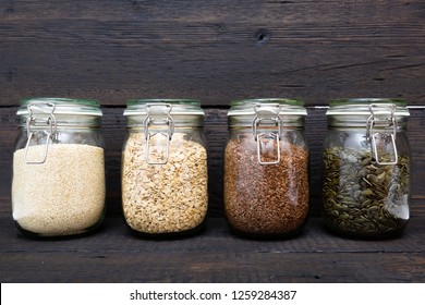 Various Seeds In Storage Jars In Pantry, Dark Wooden Background. Smart Kitchen Organization