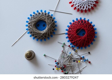 Various sewing supplies, Sewing thread spools, sewing needles, pins and thimble