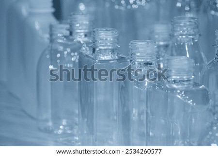 The various  shape of PET bottle in the light blue scene. The plastic bottle manufacturing concept.