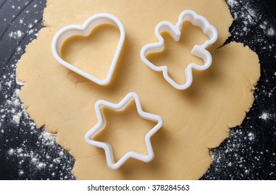 Various shaped cookie cutter on dough preparing cookies concept