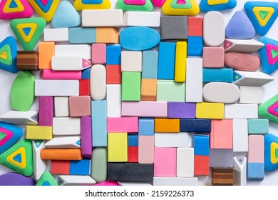 various shapes and colors of erasers arranged