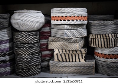 Various shapes of rattan baskets, handwoven with natural fibers, display intricate designs and forms, from round to oval and square, showcasing traditional craftsmanship and organic beauty. - Powered by Shutterstock