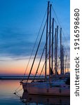 Various ships and boats in a marina of Thessaloniki, Greece at sunset