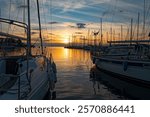 Various ships and boats in a marina of Thessaloniki, Greece at sunset