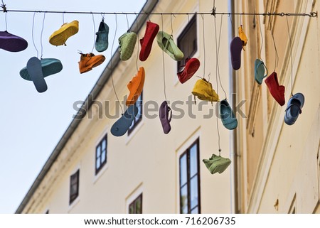 Various shoes hanging from a cable in Varazdin, Croatia
